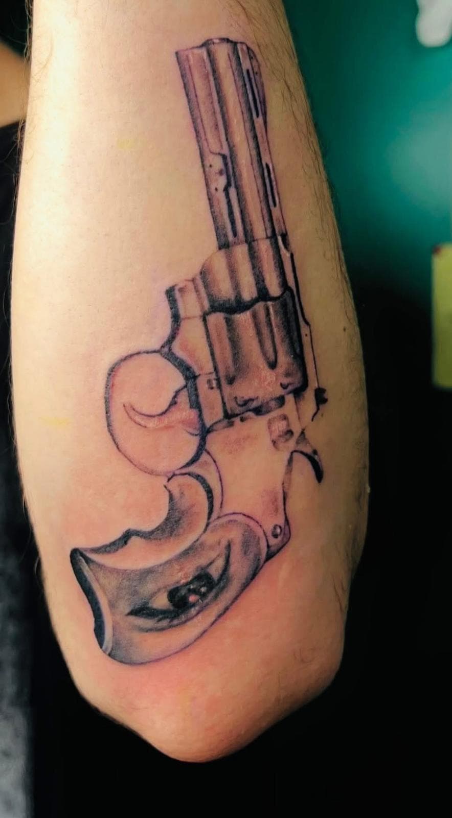 Black and grey realism revolver tattoo on arm by Alison at Inked City Tattoos in Trenton, NJ