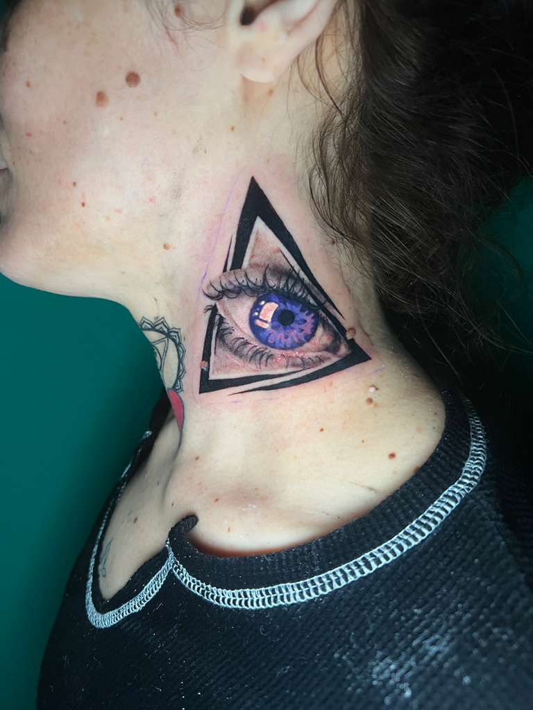 All-seeing eye in a triangle neck tattoo with purple iris by Alison at Inked City Tattoos in Trenton, NJ