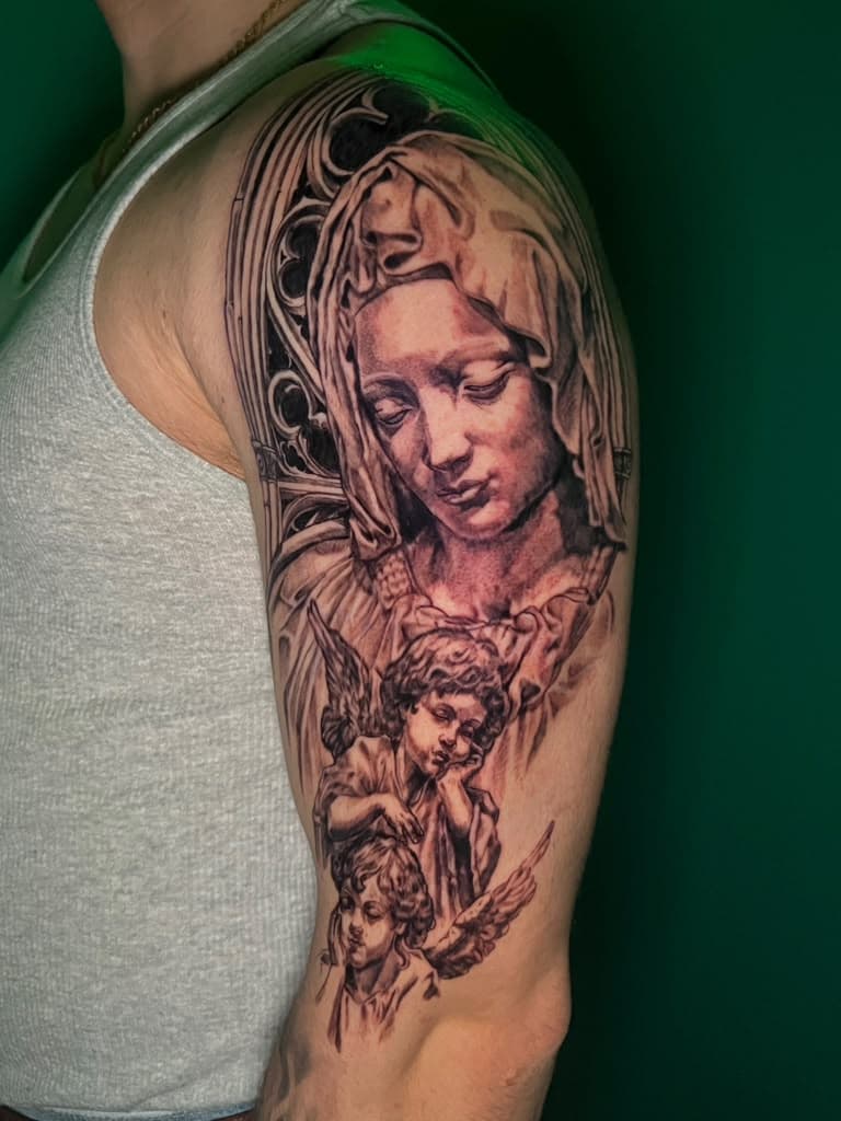 Black and grey Virgin Mary and cherub half sleeve tattoo by Alison at Inked City Tattoos in Trenton, NJ